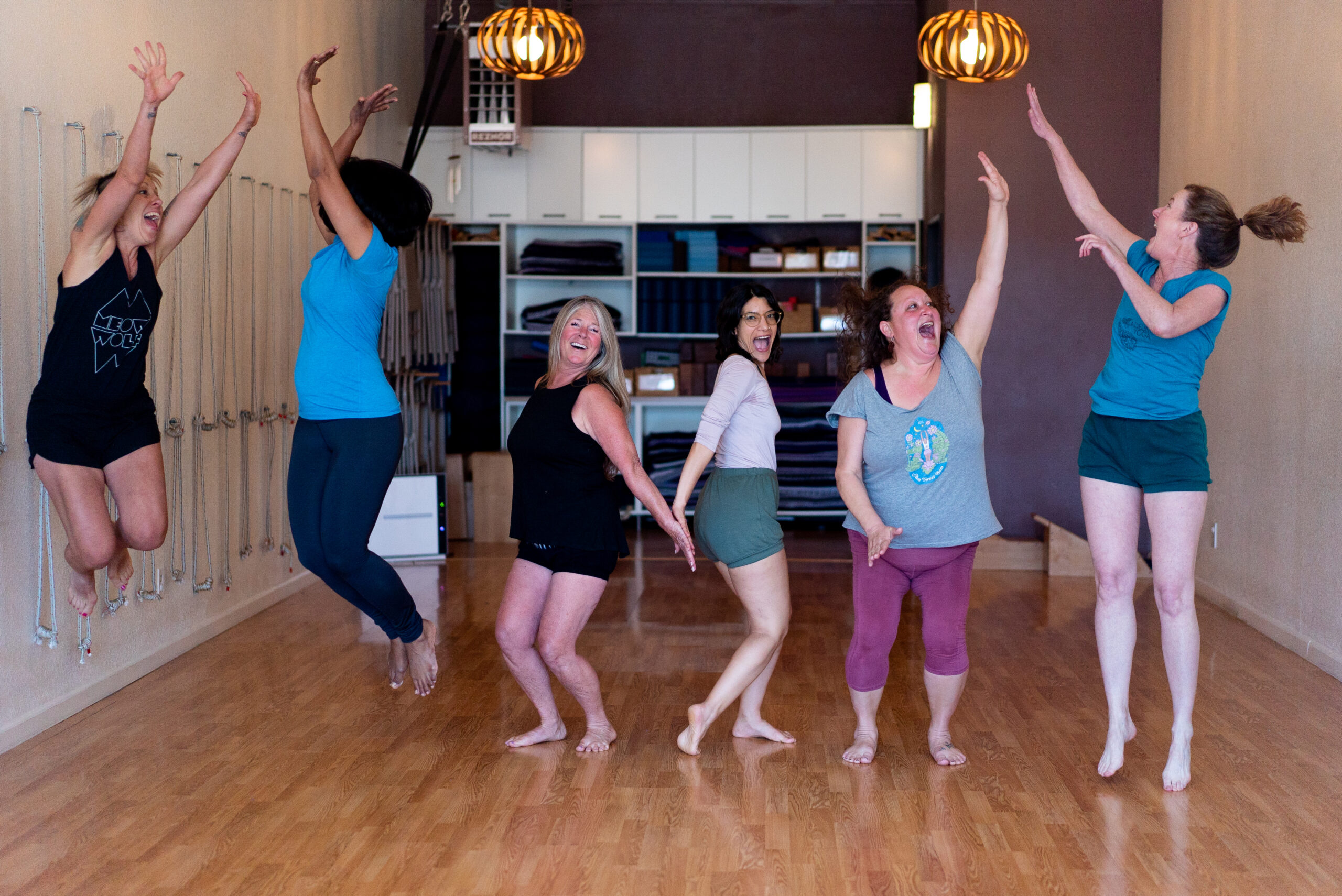 A group of Adeline Yoga students jumping for joy